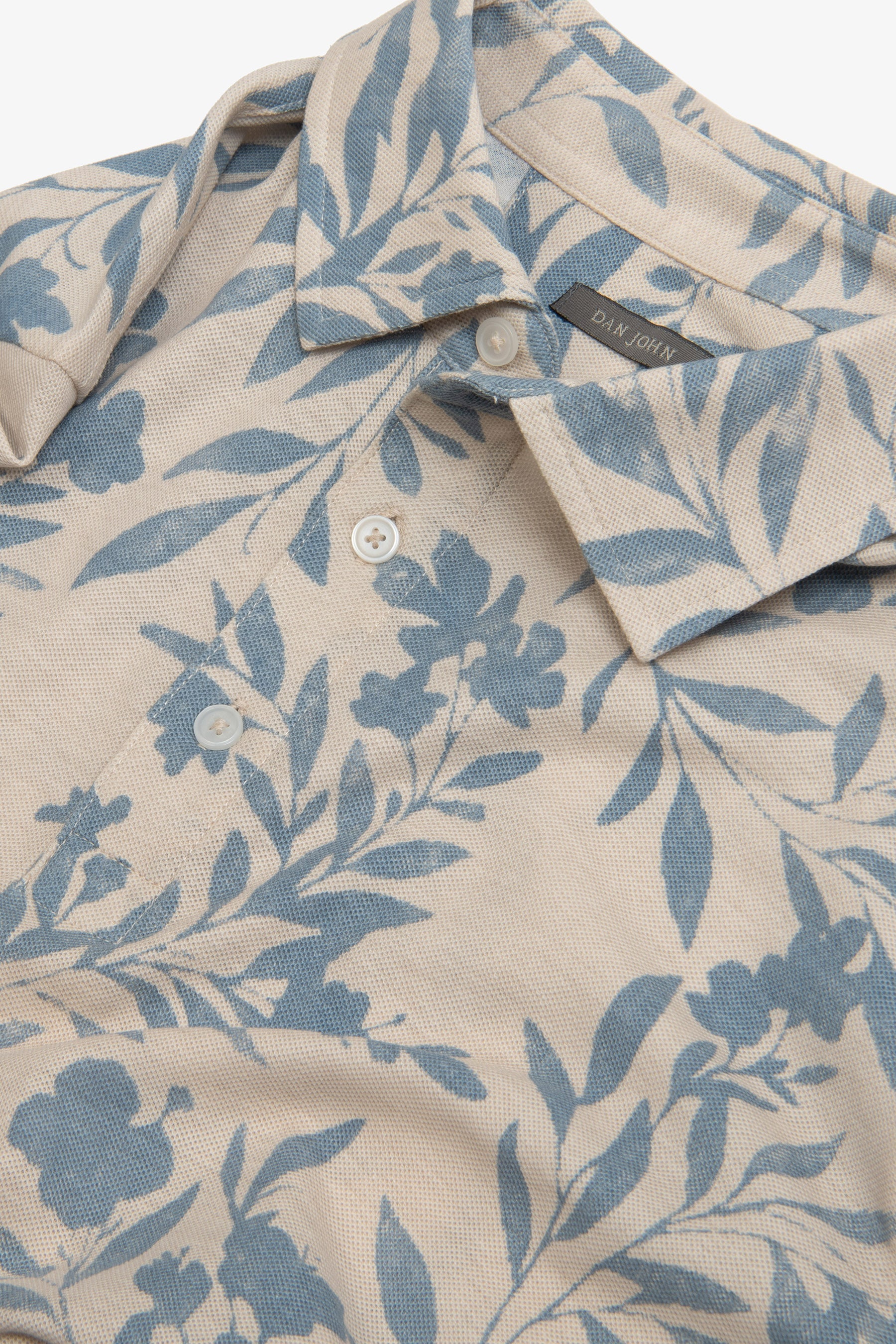 Polo in piquet fantasia fiore celeste-Dan John